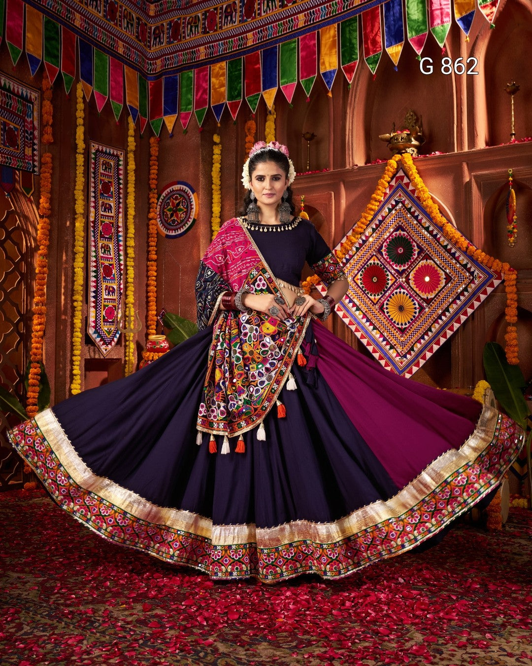 Woman in traditional embroidered outfit with colorful decorations in the background