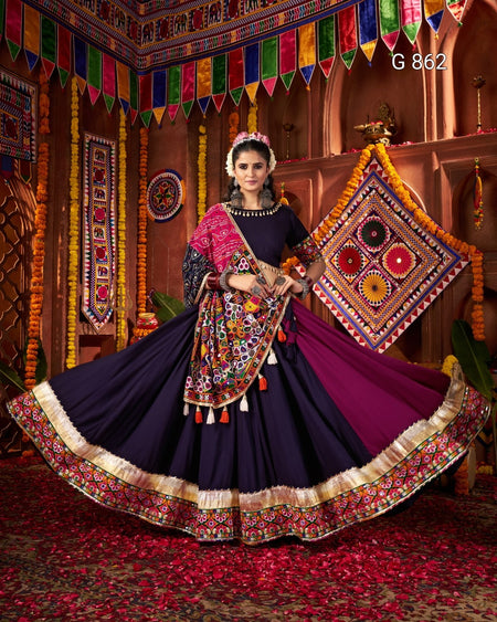Woman in traditional embroidered outfit with colorful decorations in the background