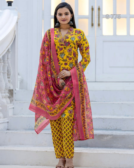 Woman wearing a yellow and pink traditional outfit with a dupatta on a white background