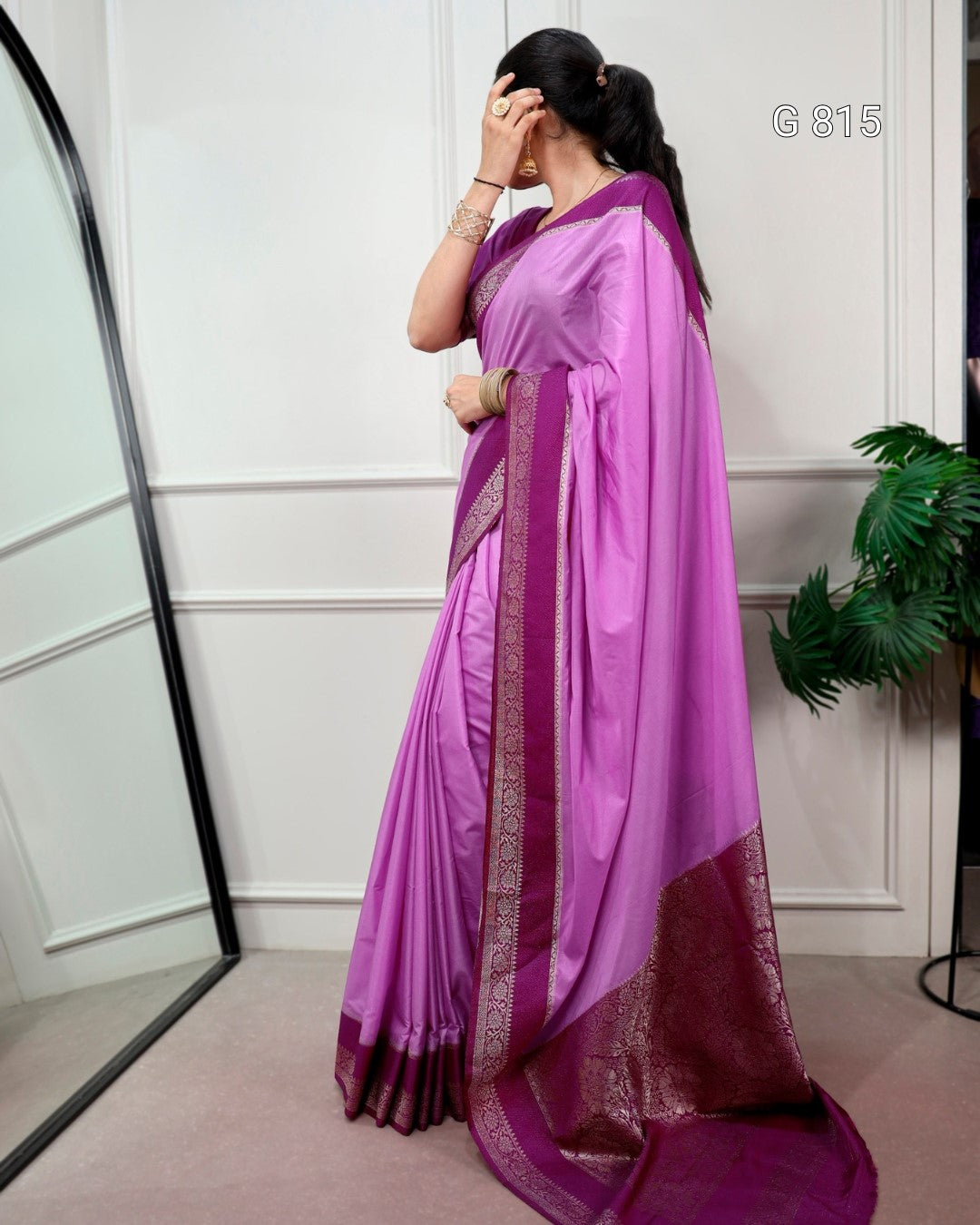Woman wearing a pink saree with a white background