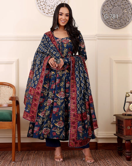 Woman wearing a floral patterned dress in an elegant room.