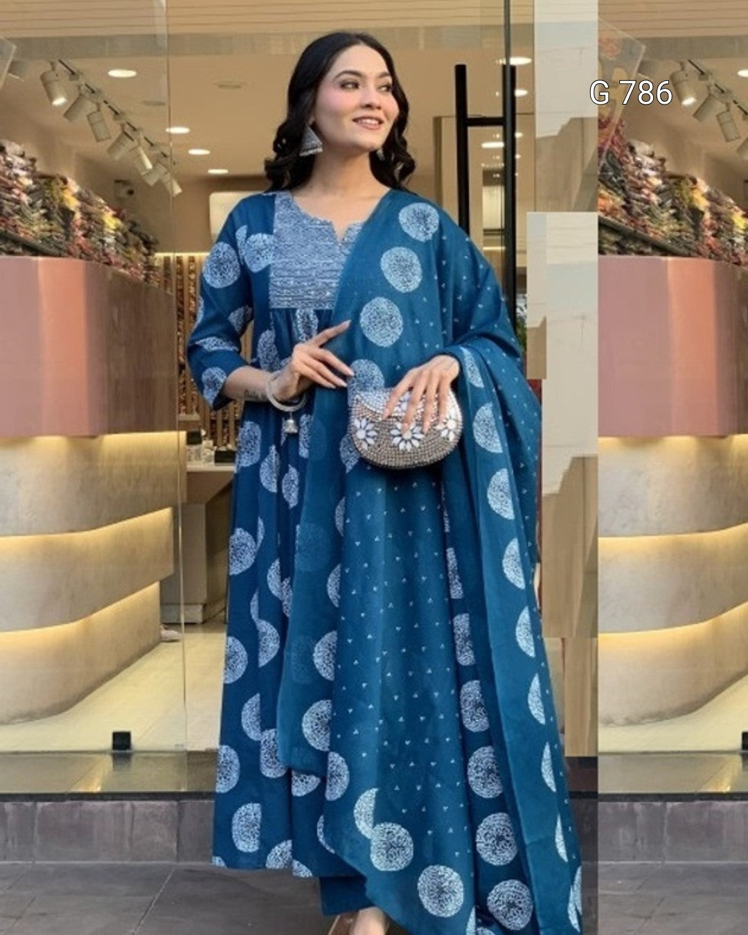 Woman wearing a blue patterned dress in a store setting