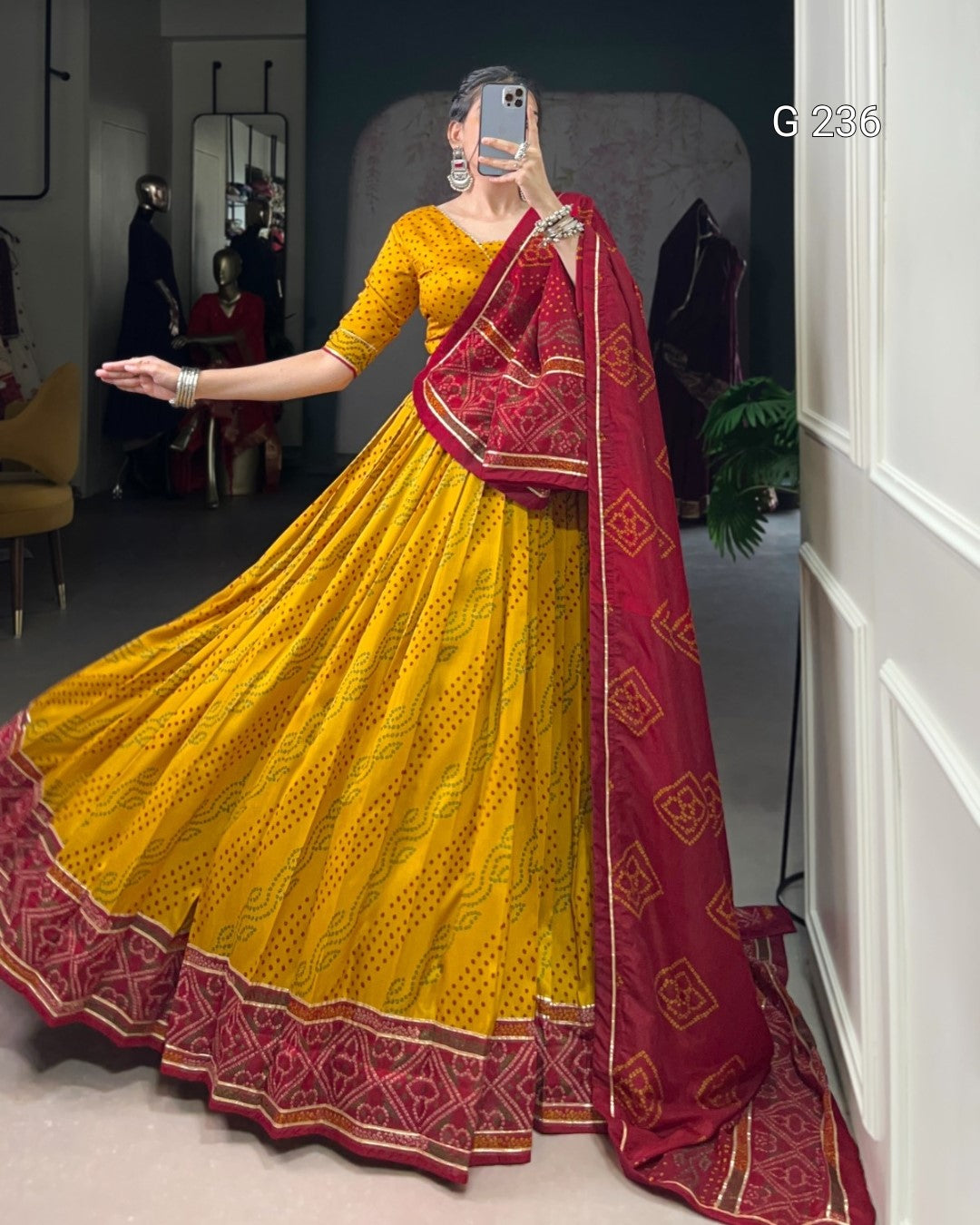 Woman wearing a yellow and red saree in an indoor setting