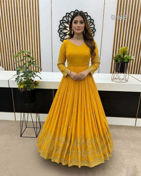 Woman wearing a yellow dress with a decorative background