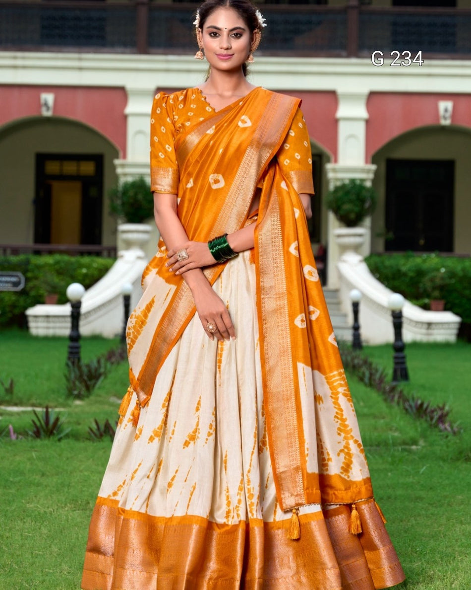 Woman wearing an orange and white saree in a garden setting