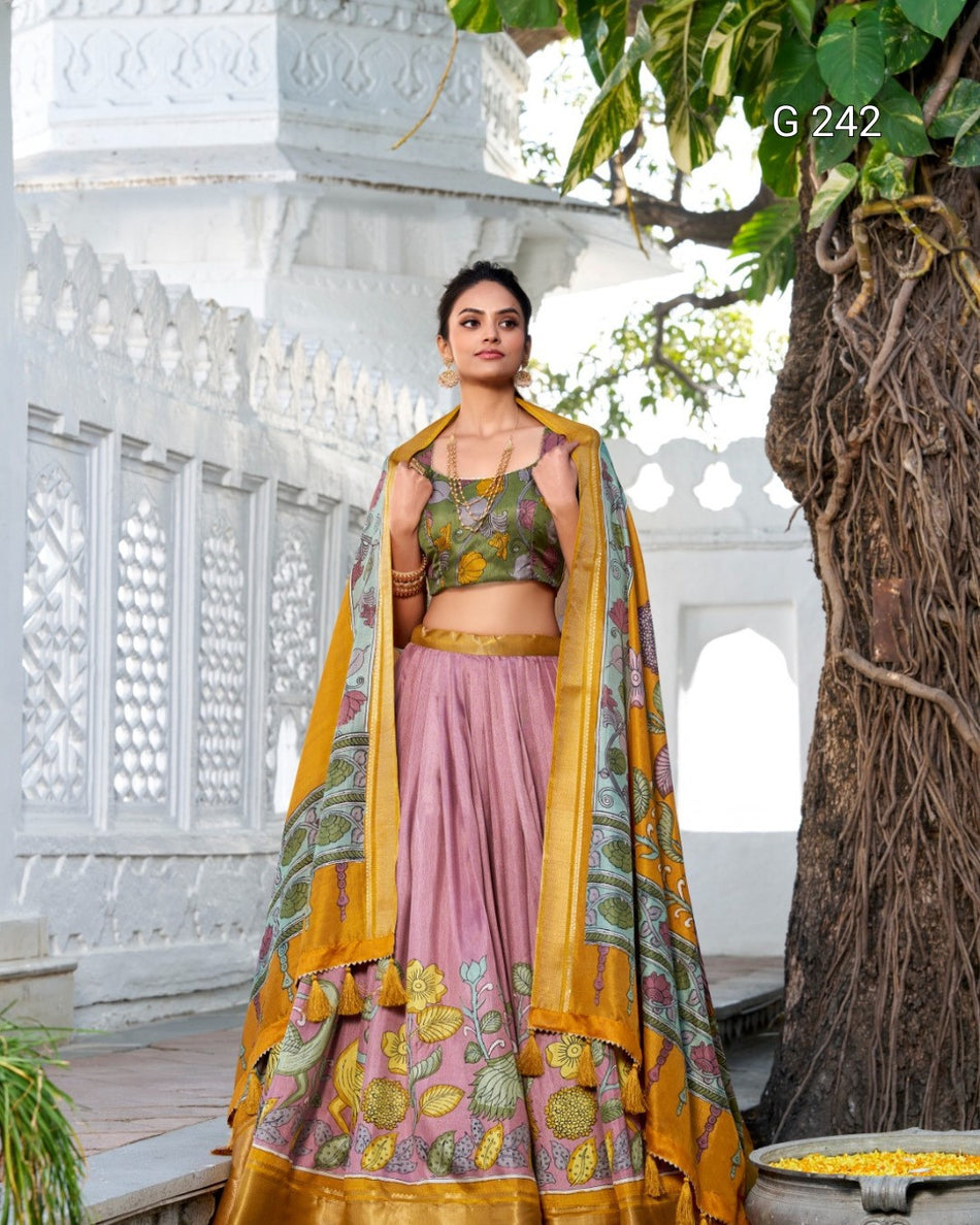 Woman in traditional outfit with a colorful dupatta standing outdoors.