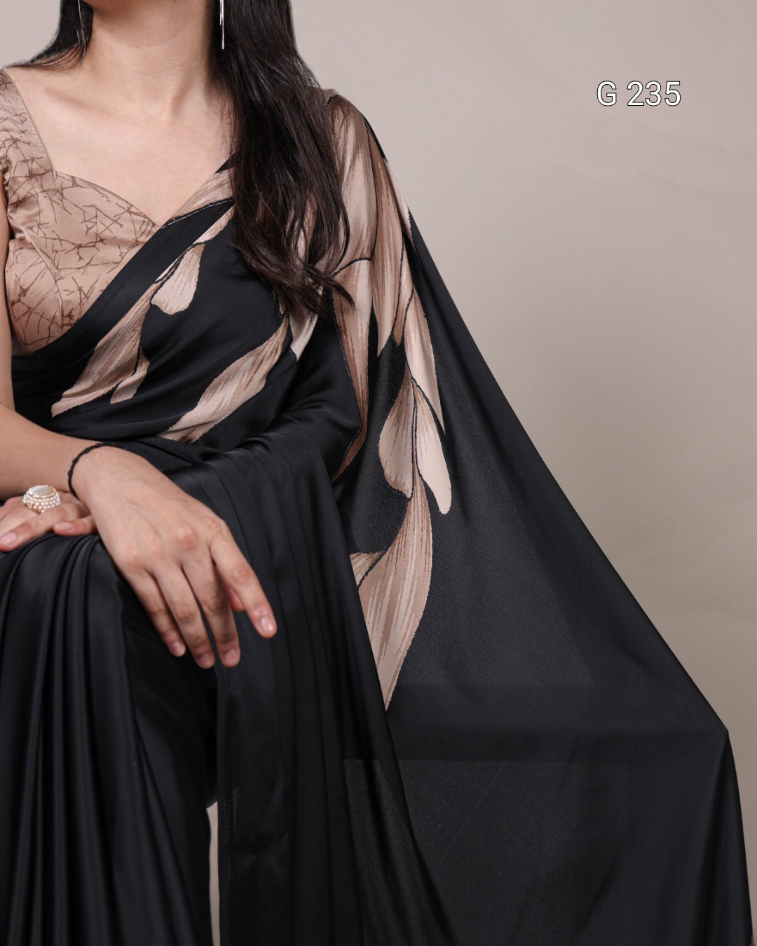 Black sheer fabric draped over a person with a neutral background