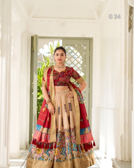 Woman in a traditional outfit with a red and beige color scheme, standing in a bright room.