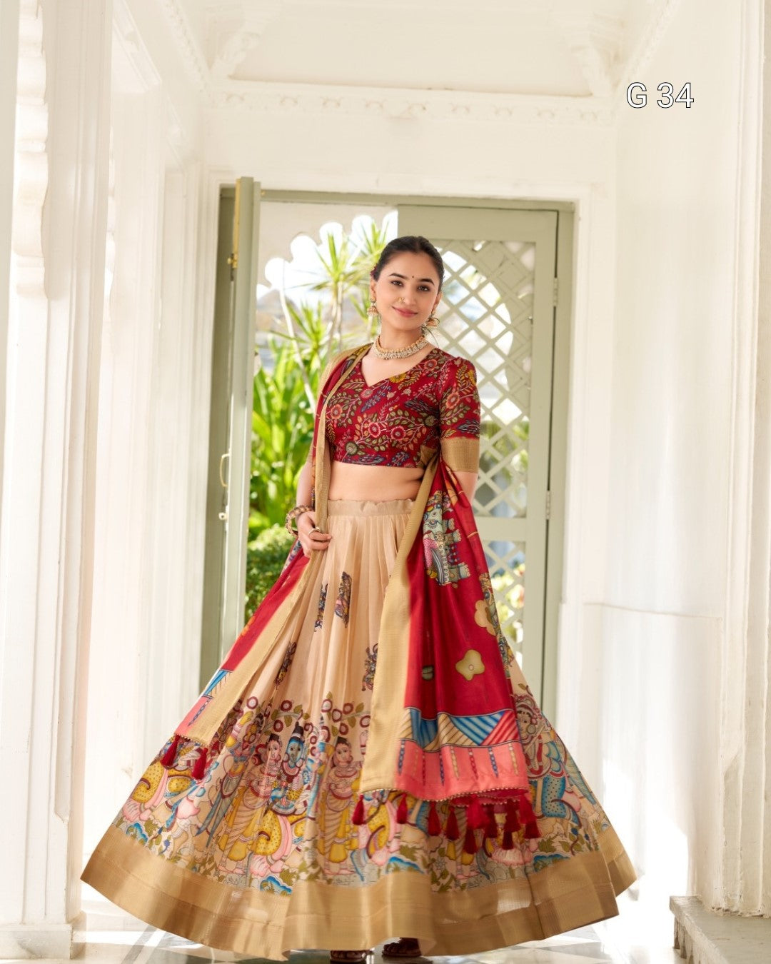 Woman wearing a traditional outfit with a colorful skirt and top in a bright room.