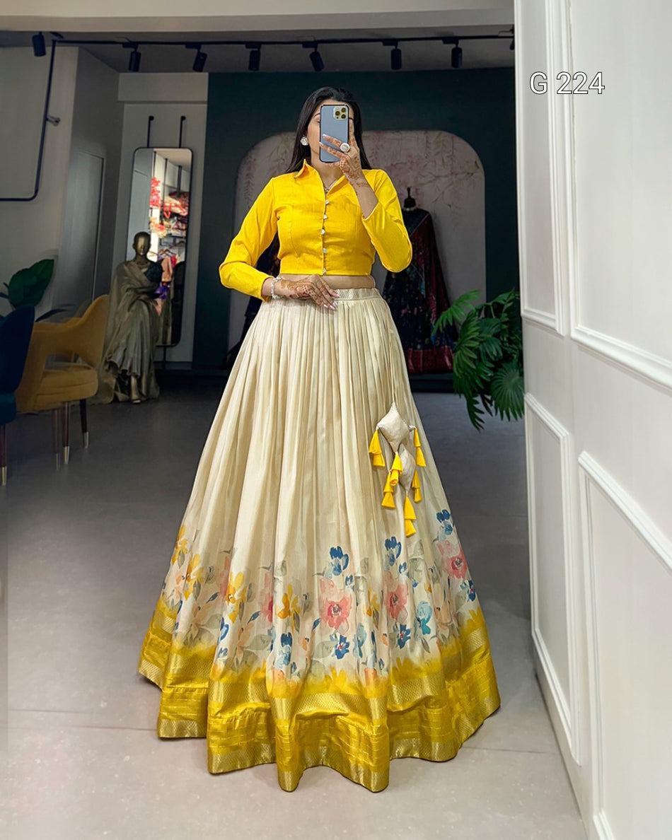 Person wearing a yellow top and cream skirt with floral design in a room.