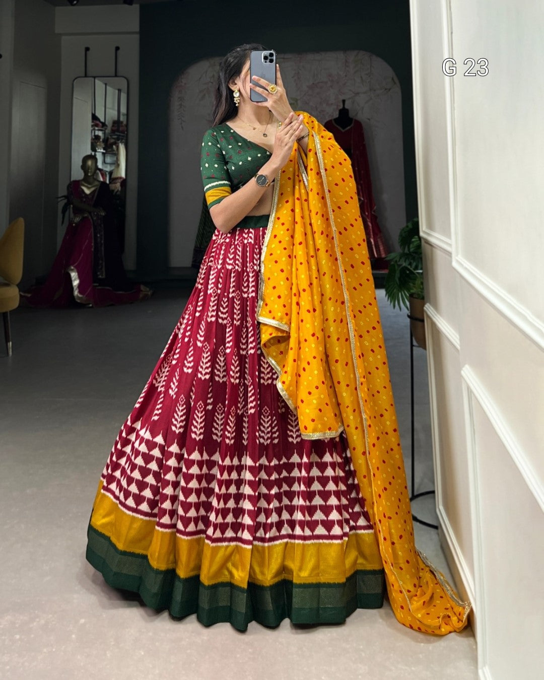 Woman in a traditional outfit with a yellow dupatta in a room setting