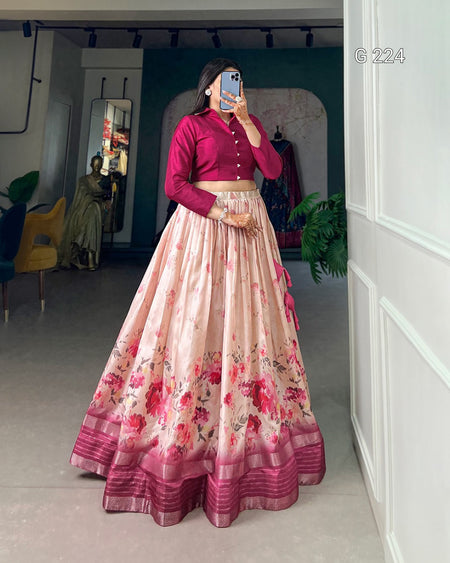 Person wearing a pink floral lehenga with a matching blouse in a room.