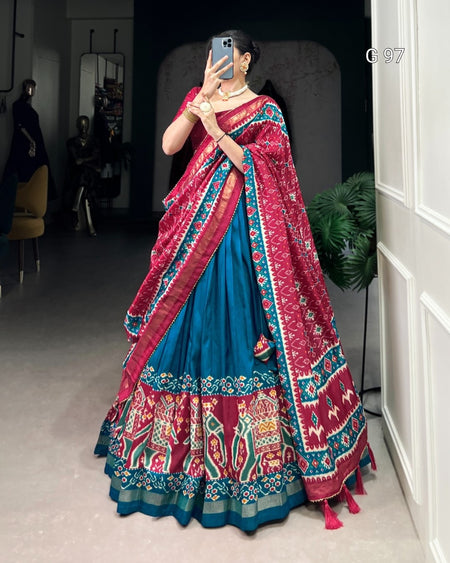 Person wearing a colorful traditional outfit with a mirror reflection.