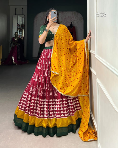 Person wearing a traditional outfit with a yellow dupatta in a room.