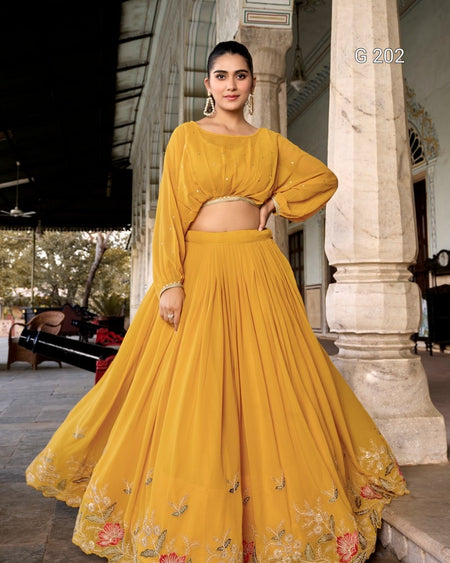 Woman in a yellow traditional outfit standing outdoors.